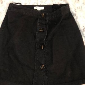 black skirt with tortoiseshell buttons